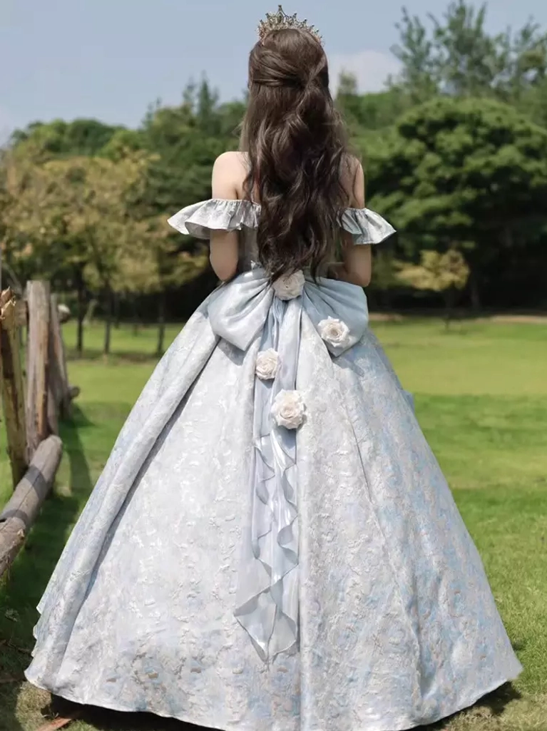 Back view full length of purple Classic Lolita gown showing large ornate bow with rose flower embellishments voluminous skirt outdoor lawn setting