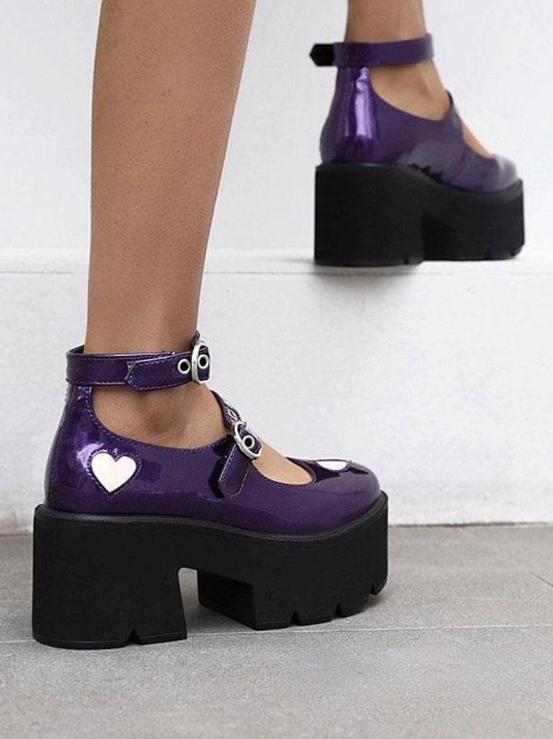 Purple lolita platform shoes side and rear partial view showing chunky black platform base and heart-shaped toe detail on patent leather upper