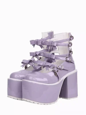 Front three-quarter view of purple patent leather Lolita platform sandals with ornamental bow buckle straps and chunky block heel on white background