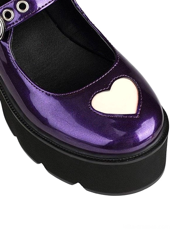 Close-up front view of purple lolita platform shoe showing heart-shaped toe detail and black chunky platform sole with patent leather construction
