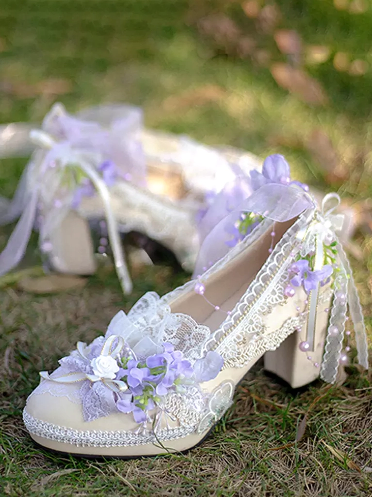 Purple Lolita high heel pump with floral decoration and beaded ribbon bow displaying lace trims and chunky block heel photographed overhead on grassy lawn