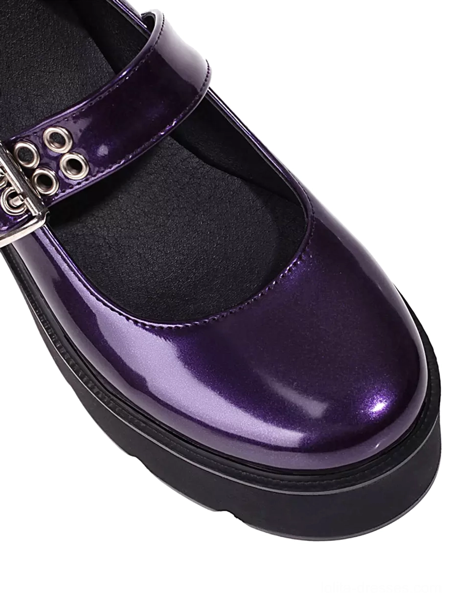 Close-up front view of purple platform Mary Jane lolita shoes showing wide ankle strap with metal eyelets and thick black platform sole