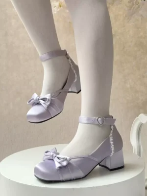 Purple sweet lolita chunky heel pumps with ankle buckle strap and front bow detail, shown in side view on model wearing white sheer tights