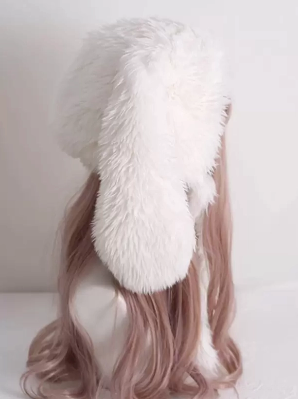 Right side profile view of plush white rabbit ear lolita headdress showing single ear, smooth hat back, long soft fur trim detail on bald mannequin display