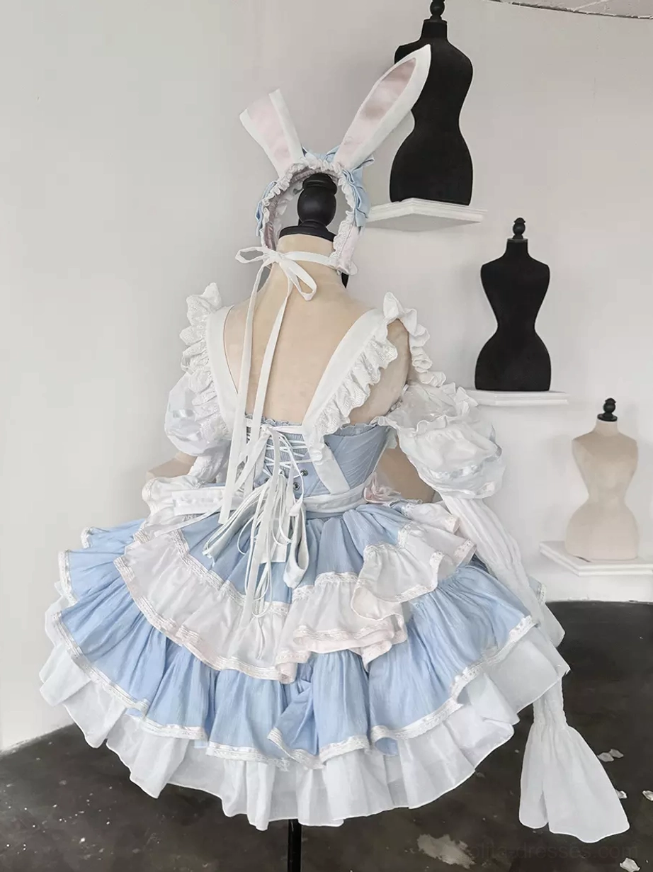 Back view of rabbit maid lolita dress showing lace-up corset back design, layered ruffled skirt, and ribbon bow accent in tiered sweet lolita style