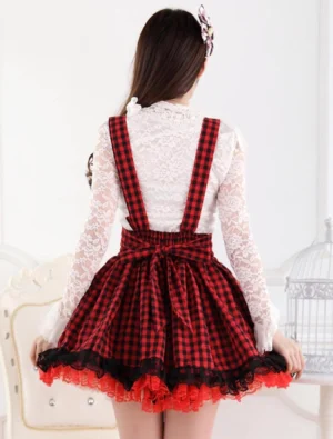 Back view of red and black gingham lolita suspender skirt showing decorative bow accent and back waist detail with refined finish