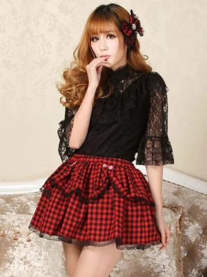 Red black buffalo plaid lolita skirt with black lace hem ruffle and matching plaid bow waist accent three-quarter view