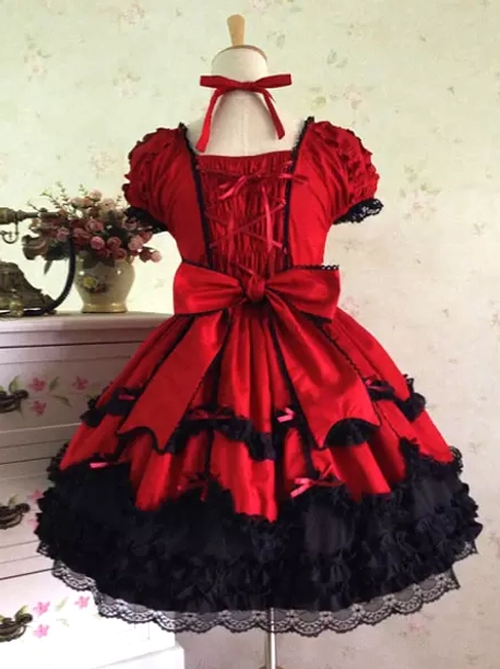 Red and black rococo lolita dress back view showing large bow and pleated layered skirt