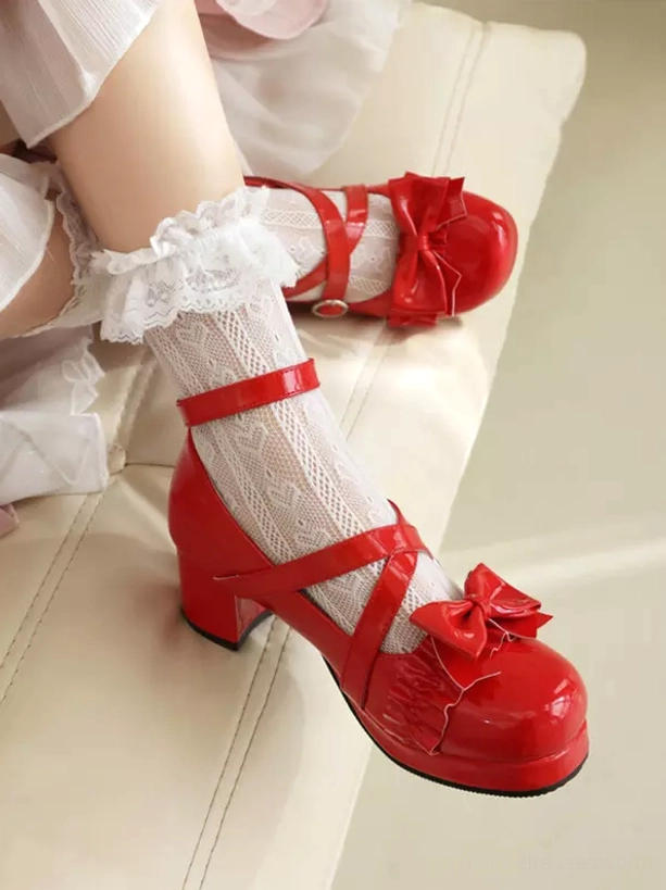 Red glossy Lolita chunky heel pumps side three-quarter view with cross ankle straps, red front bow, and thick platform heel, paired with lace-trimmed white socks