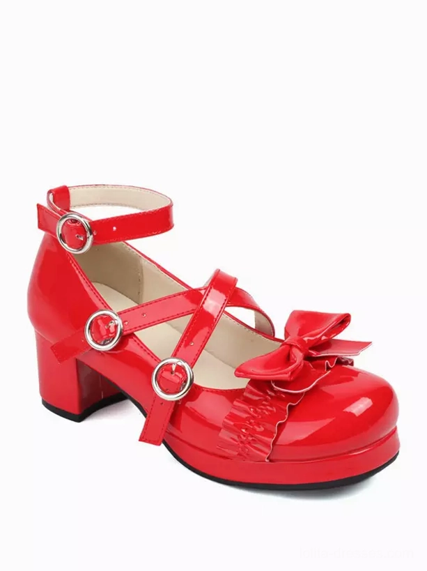 Red glossy Sweet Lolita platform pumps front flat view on white background, showing cross straps with metal buckles, prominent front bow, and thick block heel