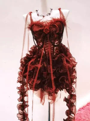 Red gothic lolita corset dress rear oblique view showing feathered ruffled skirt and beaded chain lace straps on dress form