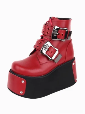 Red Gothic Lolita platform ankle boots with silver skull buckles and riveted details, left front three-quarter view showing smooth PU leather finish and decorative hardware