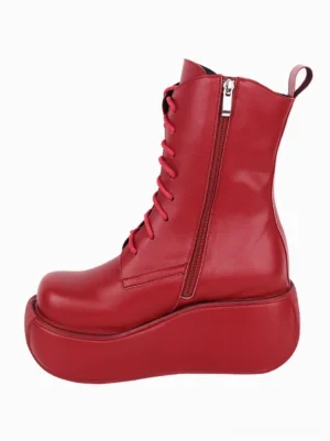 Red gothic lolita platform boot left side three-quarter view displaying side zipper pocket with ring pull and heel tab detail