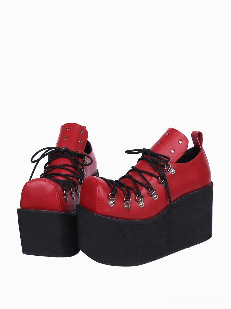 Red gothic lolita platform pumps with black wedge sole and laces, silver metal grommets, front three-quarter paired view in bold dramatic colorway