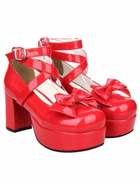 Red lolita platform pumps angled side view pair, displaying glossy PU leather, front bow decorations, cross buckle ankle straps, and thick platform soles