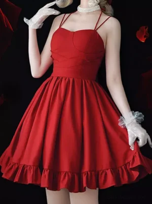 Red halter sweetheart sweet lolita slip dress with gathered waist and ruffled hem half-body view on model wearing white gloves and pearl choker dark background