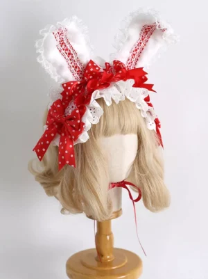 Red lace bunny ear lolita headdress with polka-dot bows and white ruffled trim front view on blonde mannequin