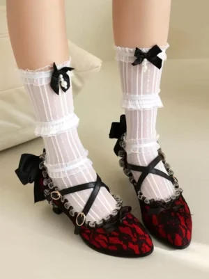 Red lace Lolita kitten heel shoes with black cross straps, overhead front view of feet wearing ruffled white socks with bow details, sweet Lolita footwear styling