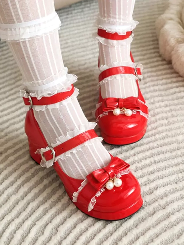 Red Lolita block heel Mary Jane pumps with red pearl bow and ruffled red ankle straps, front close-up on model wearing striped sheer lace socks with glossy finish