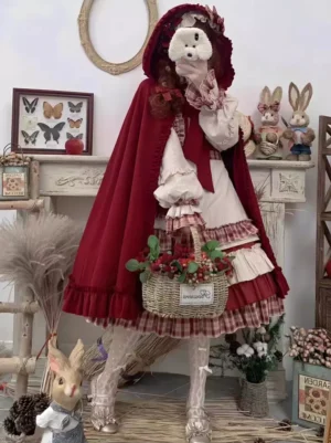 Three-quarter view of red sweet Lolita dress ensemble with cape draped over shoulders and flower basket accessory