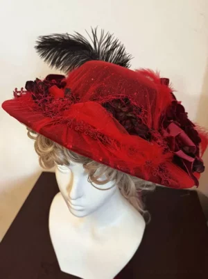 Wine red lolita formal headdress with black feather and red tulle fabric flower clusters left front angle view gothic aesthetic
