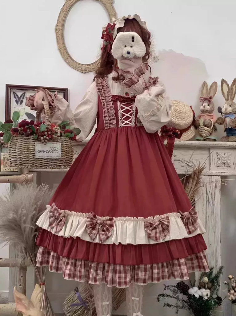 Red Lolita jumper skirt with long-sleeve inner shirt layered under showing lace-up bodice and tiered ruffled construction