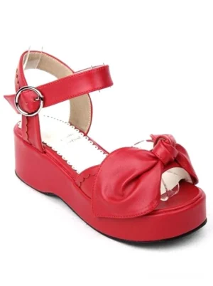 Red lolita platform wedge sandals side oblique angle showing prominent bow decoration thick sole profile metal ankle buckle fastening