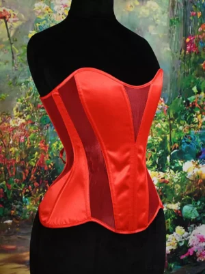 Red satin overbust corset with vertical mesh side panels and boned structure side-front angle on mannequin