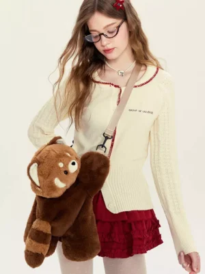 Red panda plush crossbody bag worn by female model in sweet lolita outfit, showcasing brown corduroy fabric with fuzzy tail detail and adjustable shoulder strap