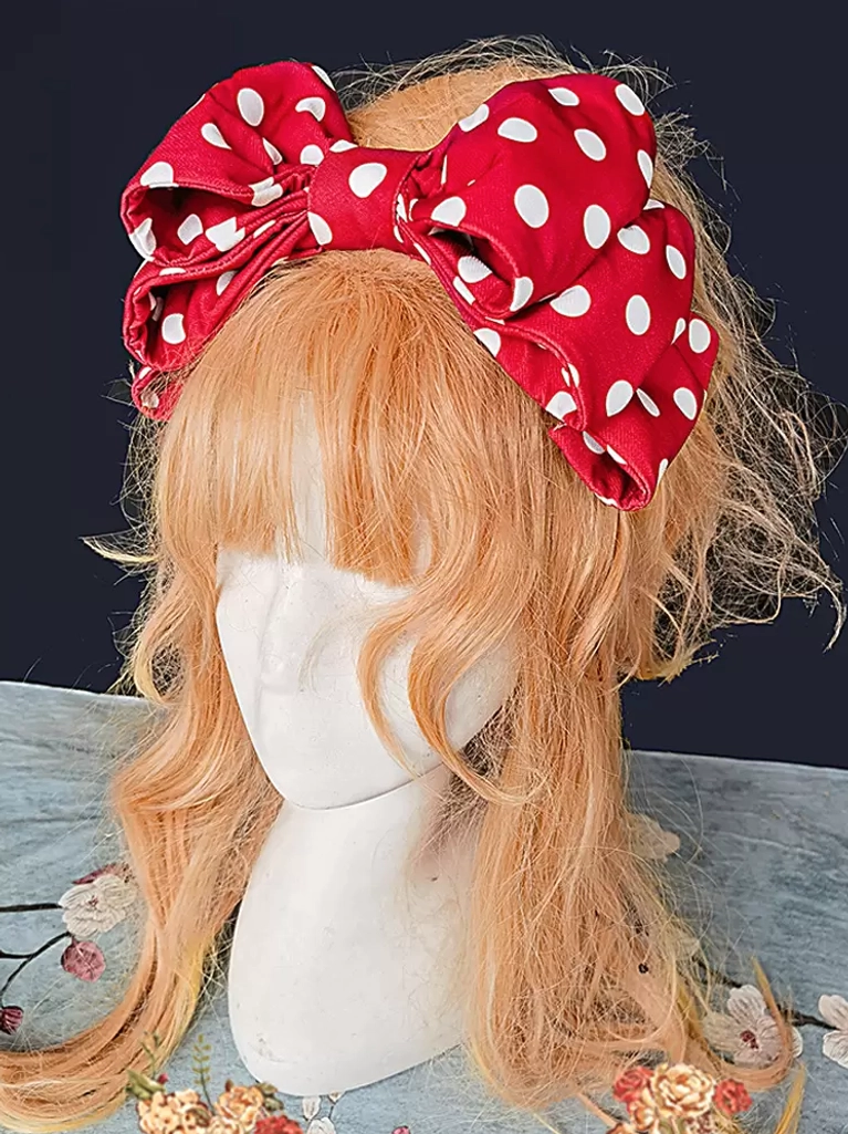 Red polka dot sweet lolita oversized bow headdress front close-up view on blonde curly wig with white dots detail
