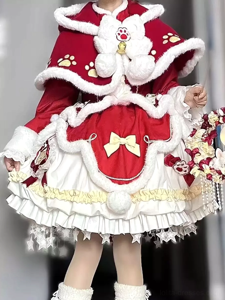Front close-up detail of red Sweet Lolita dress featuring cream ruffled trim, star tassel skirt hem, fluffy cape trim, decorative bow elements held with floral bouquet accessory