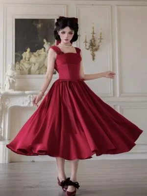 Red sweet Lolita midi dress front view with square neckline, flutter ruffled straps, corset waist and flowing swing skirt worn by model with vintage styling