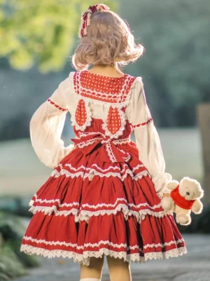Red sweet lolita jumper skirt back view showing polka dot yoke back waist bowknot detail outdoor lawn