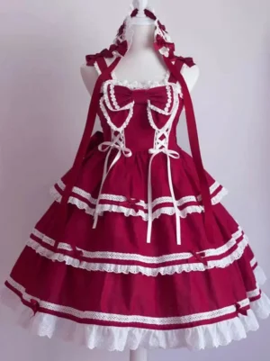Red sweet lolita jumper skirt dress front view showcasing oversized bow front bow lace-up details tiered ruffled hem lace trimmings on dress form