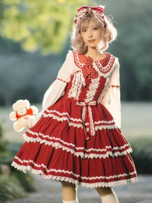 Red sweet lolita jumper skirt JSK dress with white lace trims and tiered ruffled skirt front three-quarter view model outdoor holding plush toy