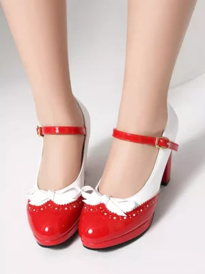 Red and white perforated Mary Jane platform shoes with decorative bow and block heel front view worn on bare legs