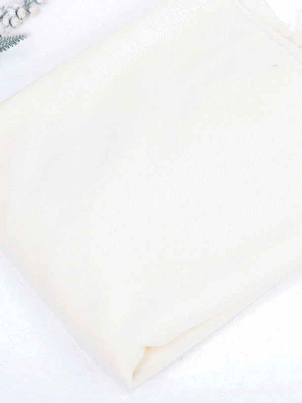 Flat lay view of cream white smooth matte polyester plain scarf lolita accessory on light decorative background