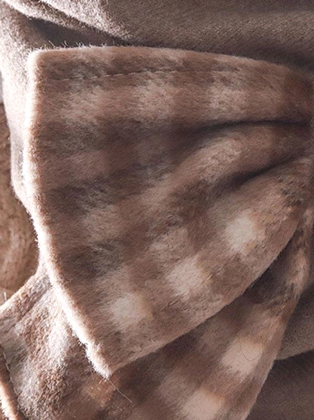 Extreme close-up side view of large fuzzy coffee brown plaid gingham bow accessory showing textured layered bow shape for lolita fashion