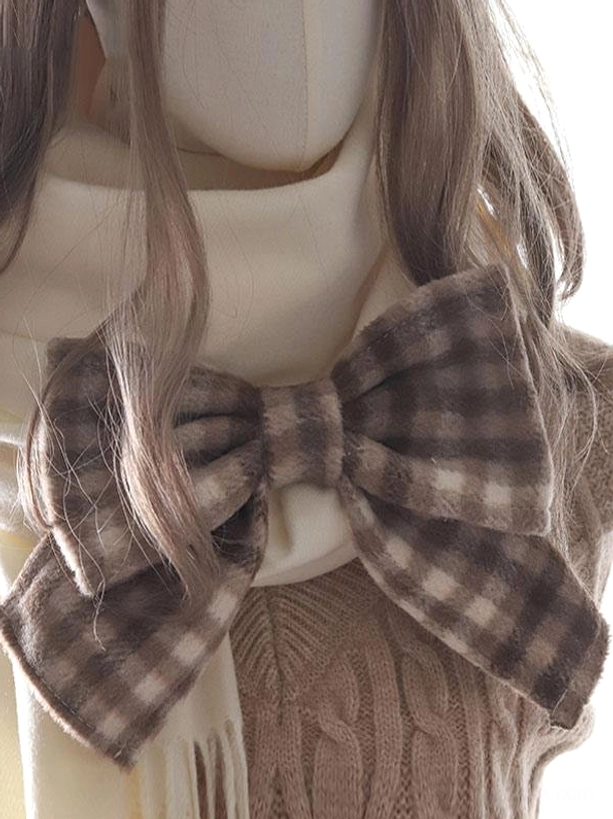 Close-up top-down view of cream brown gingham fuzzy bow lolita scarf accessory with knitted sweater background details