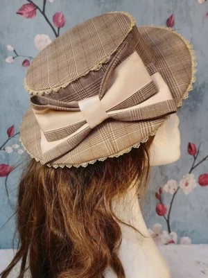Brown plaid rococo lolita flat-top hat with beige bow and lace trim on mannequin, rear view showcasing classic lolita headdress design