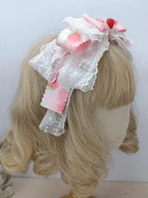 Rococo Lolita headwear rear side view showing pink and white lace bow with hanging decorative lace tassels detail shot