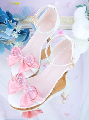 Rococo lolita heel sandals white leather pink satin bow gemstone accents overhead close-up view floral backdrop