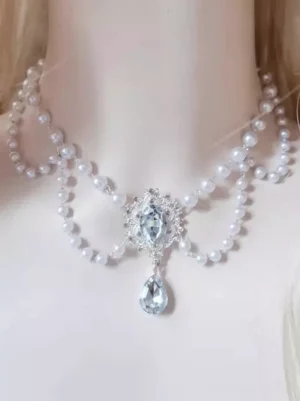 Rococo pearl choker with clear rhinestone pendant worn on mannequin neck, featuring double-layer white pearl chain and silver filigree setting with oval and teardrop crystals