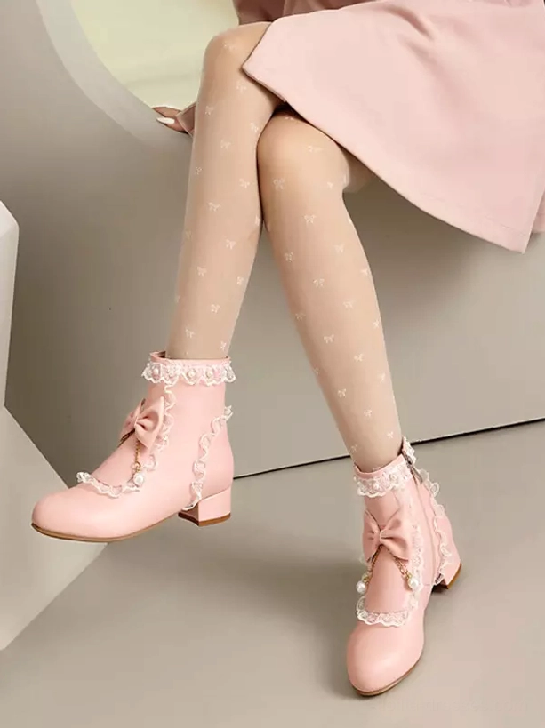 Top-down front view of pink rococo lolita ankle boots displaying round toe shape, low block heel profile and ornate bow with layered lace decorations