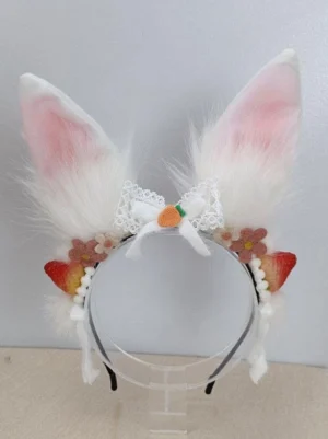 Front view of white rabbit ear lolita headwear accessory with upright fluffy ears lace bow and fruit flower trims on clear plastic head mount rococo sweet style