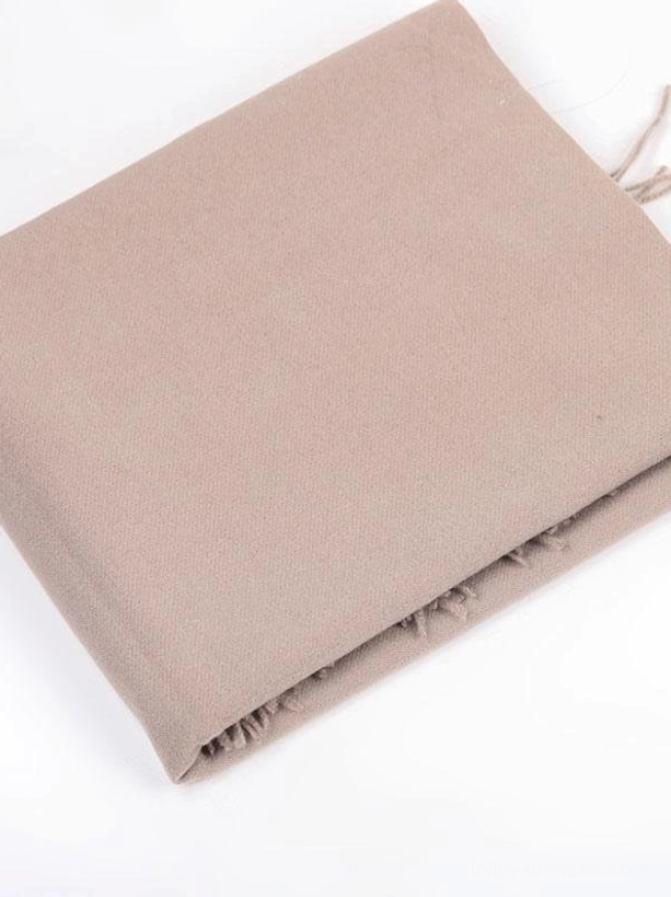 Flat lay top view of taupe brown solid color tassel scarf lolita accessory with soft woven fabric and fringe details on white background