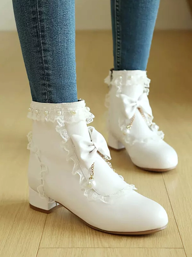 Back side view of white rococo lolita ankle boots showing decorative lace collar, pearl tassel bow charm and smooth PU leather finish with polished surface