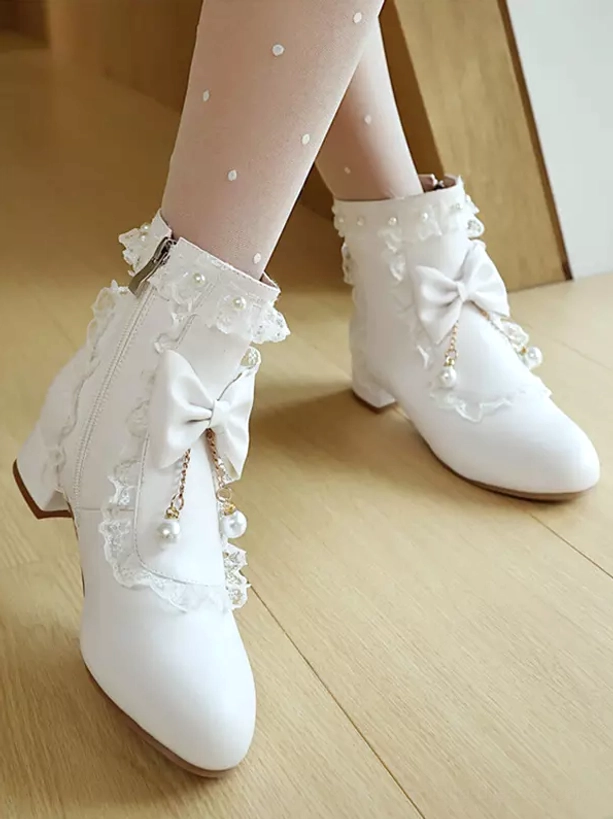 Side oblique view of white rococo lolita boots displaying side zipper closure, low block heel, lace trim details and ruffle adorned ankle collar with pearl accents