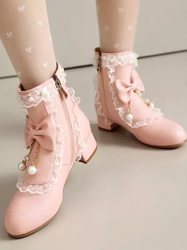 Dynamic side view of white rococo lolita boots worn with denim, showcasing decorative bow and pearl hanging ornaments combined with delicate ruffle lace detailing