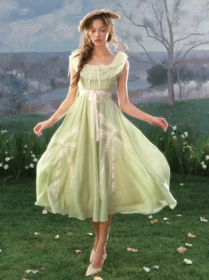 Light sage green cottagecore prairie lolita dress with ruffled square neckline and A-line skirt standing pose